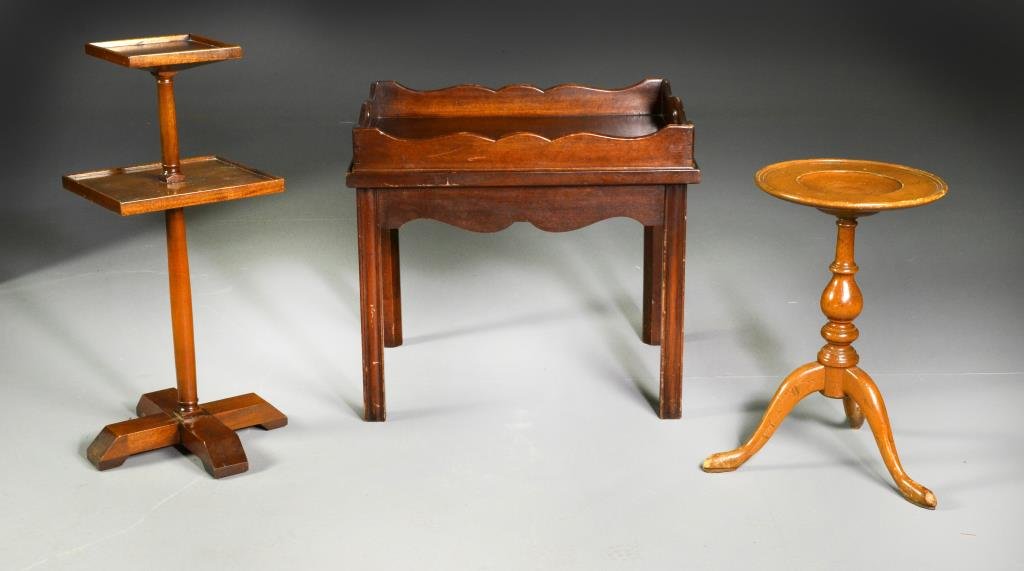 (3) Wood Serving Trays and Stands: To include a candlestand on tripod feet, a two-tiered stand raised on four supports and a butler's table with removable tray, largest measures 21.5"H x 24"W x 19"D, circa. Condition, all having overal