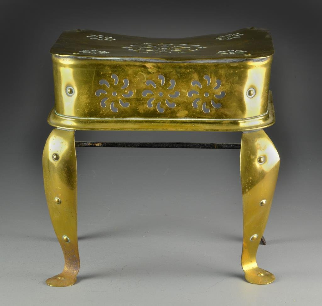 An Antique American or Continental Brass Trivet: Brass top and sides pierced with roundels, having curved brass legs, with brass tack decoration, mounted on cast iron supports, measures 13.5"H, circa 19th century. Condition: having overall surface w