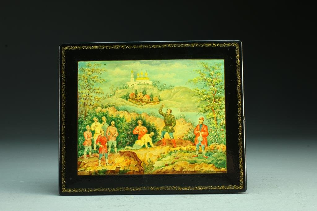 Antique Russian Lacquer Dresser Box: A fine lacquered dresser box depicting figures in a landscape scene, signed in Russian and dated "4-27-60", having gilt scrolling border, interior is a deep red lacquer with inscribed message from a l