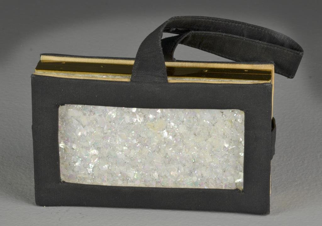 A Mother of Pearl and Brass Compact: A brass compact with layered mother of pearl to lid, with four sectioned compartments, complete with black faille handled holder, measures 3"H x 5.25"W x 1"D closed, circa early-mid 20th century. Cond