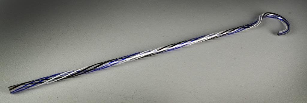 An American or Continental Blown Glass Walking Stick: Having candy cane decoration in black, white and cobalt, and having a shaped handle, measures 28"L, circa late 19th century.