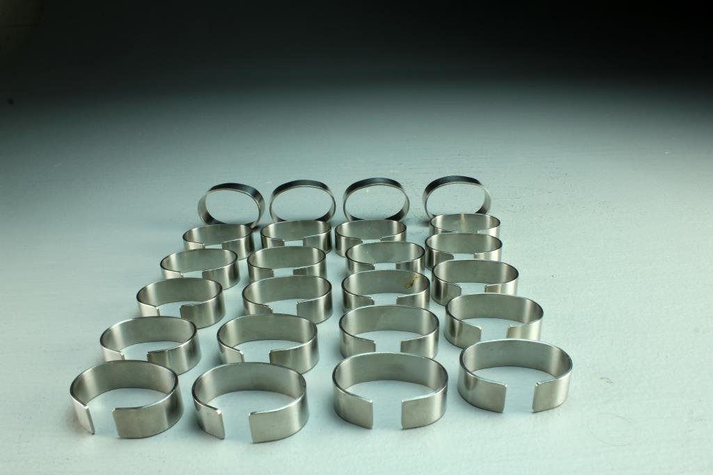 (24) Danish Stelton Stainless Napkin Rings: Of modernistic design having a smooth finish, all marked "Stelton Stainless Denmark", each measures 1.25"L, circa 20th century.
