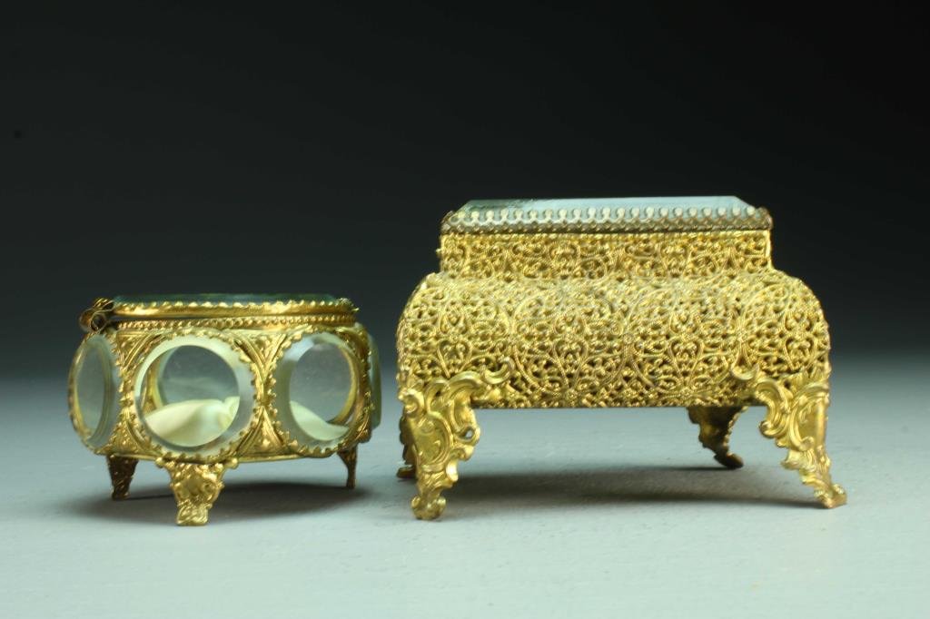 (2) Continental Gilt Metal and Beveled Glass Dresser Bo: To include a Birks box having a circular beveled glass lid with scalloped gilt metal with beveled glass medallions and stamped floral decoration raised on splayed tripod feet, marked "Birks" and "Made
