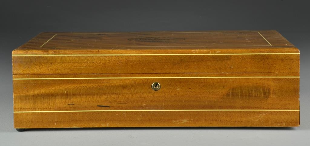 A Cuban Partagas Humidor: A wooden box humidor with inlaid lid marked for Partagas, Habana, interior with original Partagas sticker under glass and three wrapped cigars, measures 4.5"H x 15"W x 8.75"D, circa early-mid 20th cen
