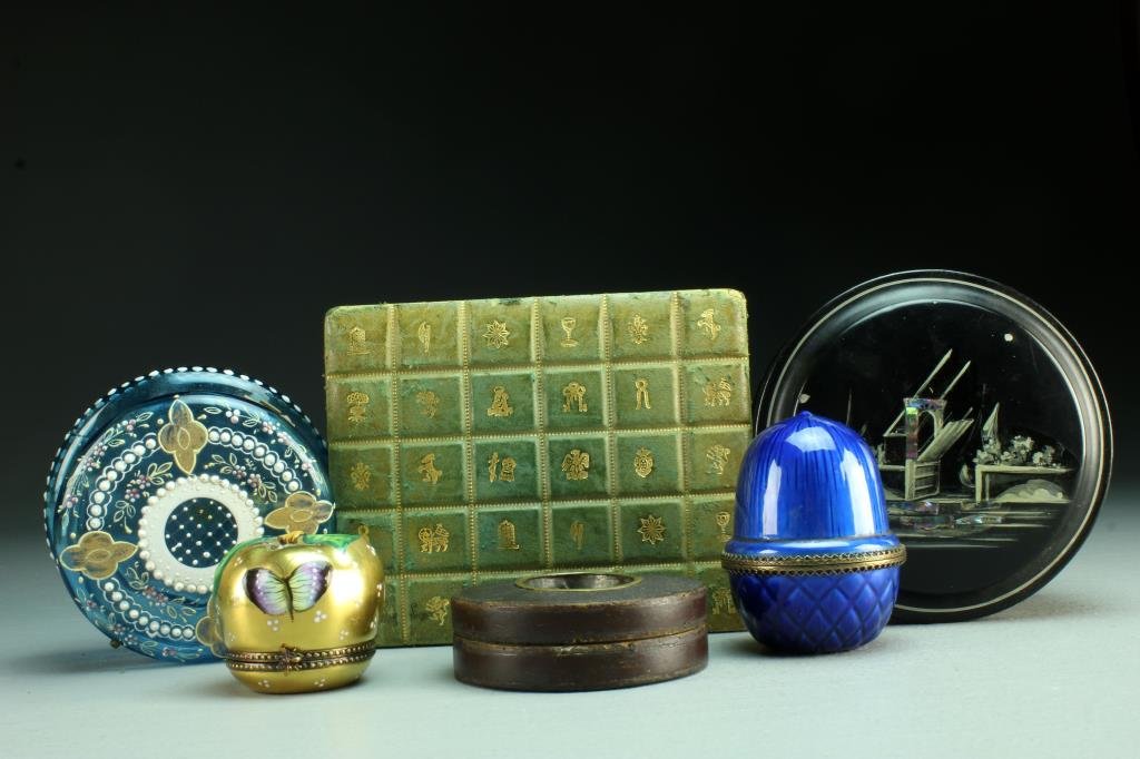 (6) American & Continental Covered Boxes: To include a Limonges French enamelled porcelain box formed as an apple decorated with butterfly and lady bugs and having a stamped insect closure, together with an Evans brass mounted enamelled box f