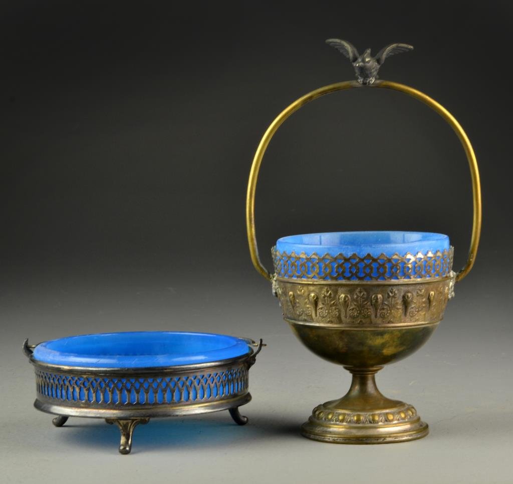 (2) Pcs Silver Plate & Glass Dishes: To include a dish with metal bird affixed to handle, raised on foot and having pierced and repoussé bands of decoration to body, along with a pierced dish with handle raised on tripod feet, each with
