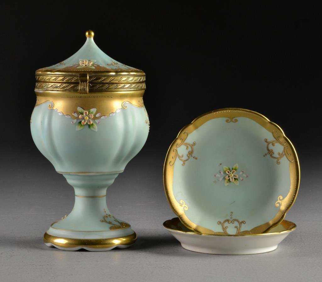 A (3) Pc German Gilt Decorated Porcelain Garniture: To include a covered urn and two small dishes, having raised enamel and raised gilt decoration against a celeste blue ground, urn measures 7"H, circa early 20th century.