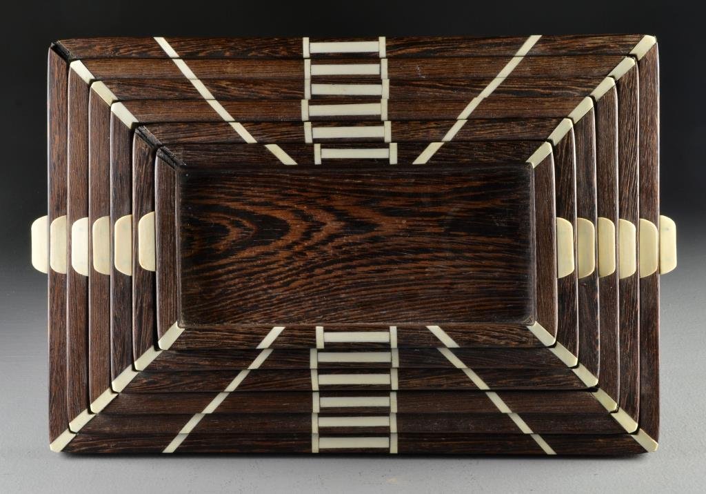 An Art Deco Ivory and Teak Graduated Tray Set: Having six graduated teakwood trays inlaid with ivory fittings, purchased in the Belgium Congo in 1963 by the consignor, largest tray measures 17.5"W, circa early-mid 20th century. Condition: two ivor
