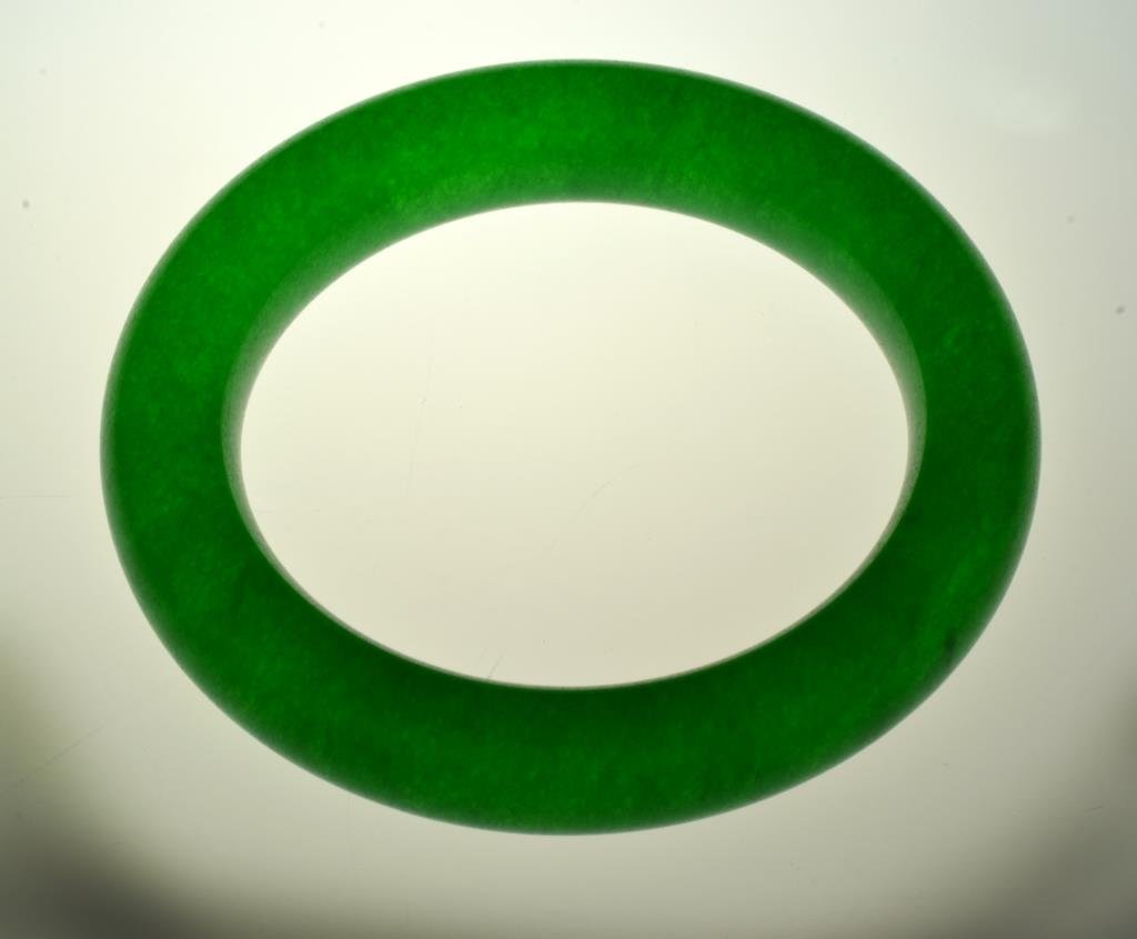 A Chinese Jade Bangle Bracelet: Uncarved in deep emerald green, having a finely polished surface, outside diameter is 3.5"Dia.