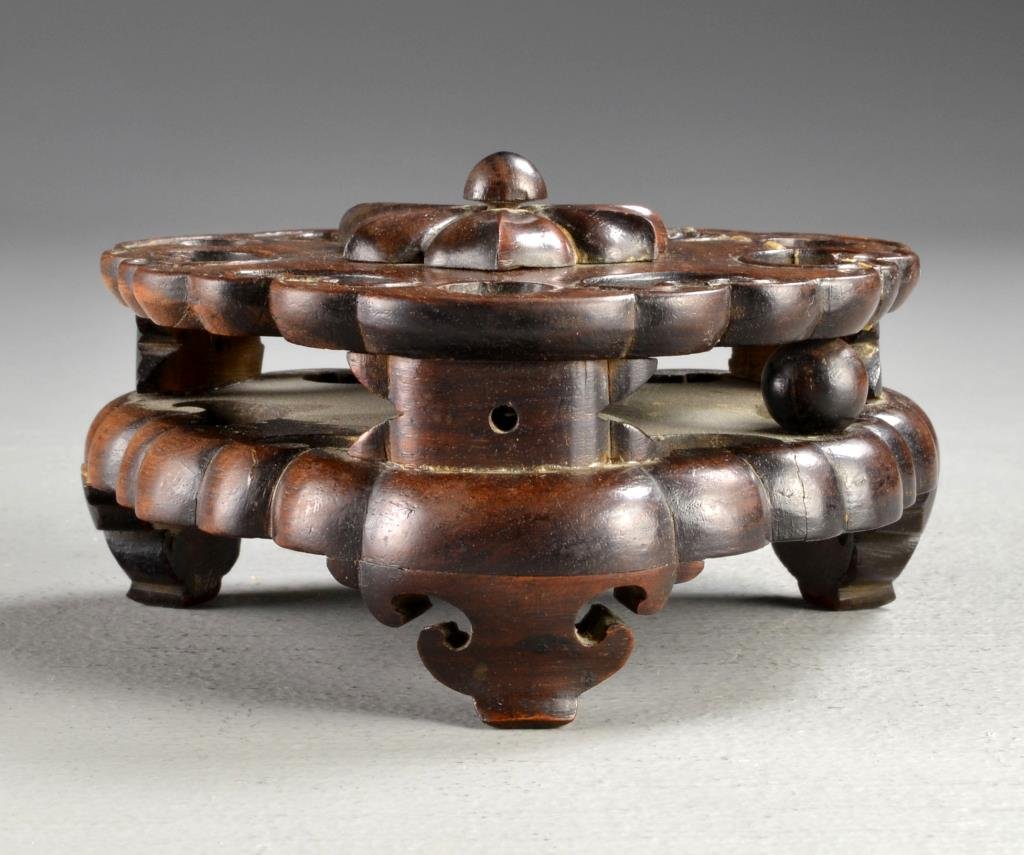 A Fine Chinese Qing Hardwood Stand for Censer: A three footed stand having a rotating lotus blossom to the top center and fine open work carving throughout, measures 3.25"H x 5.75"Dia., circa 19th century.