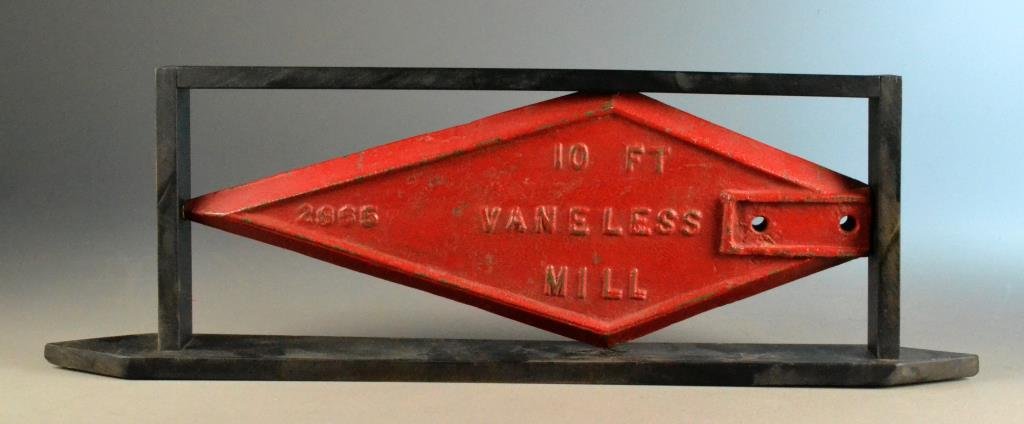 Challenge Spear Windmill Weight: Red painted spear shaped windmill weight by Challenge Co. Batavia, ILL., back reads 10ft. Vaneless Mill 2865, framed in black wood base, 23" L, circa late 19th/20th century. Condition: Wear to paint. 