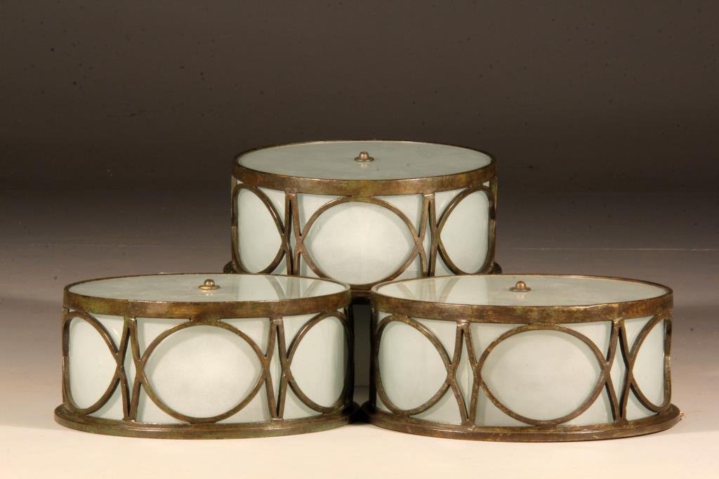 (3) Strap Iron Ceiling Lights: In the modernistic taste, having a golden bronze patina, 13"D x 6"H, circa 20th century.
