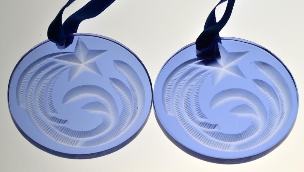 (2) Lalique Glass Pendants: Having stars and moon decoration in blue glass each in original box, 2.625"D, circa 20th century. Provenance: Formally in the collection of Gary Culpepper of Culpepper Galleries-Santa Fe, New Mexico.