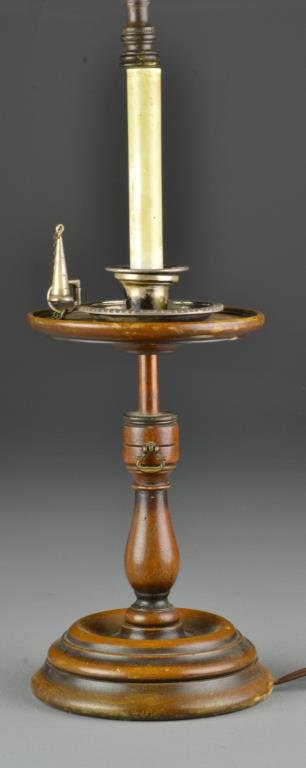 An Antique Turned Wood & Metal Candlestick Lamp: An antique metal chamberstick with thumb piece and snuffer mounted on a turned wood candlestick with stepped round base, later electrified as a lamp, measures 10.5"H to top of chamberstick, 29.5"H to 