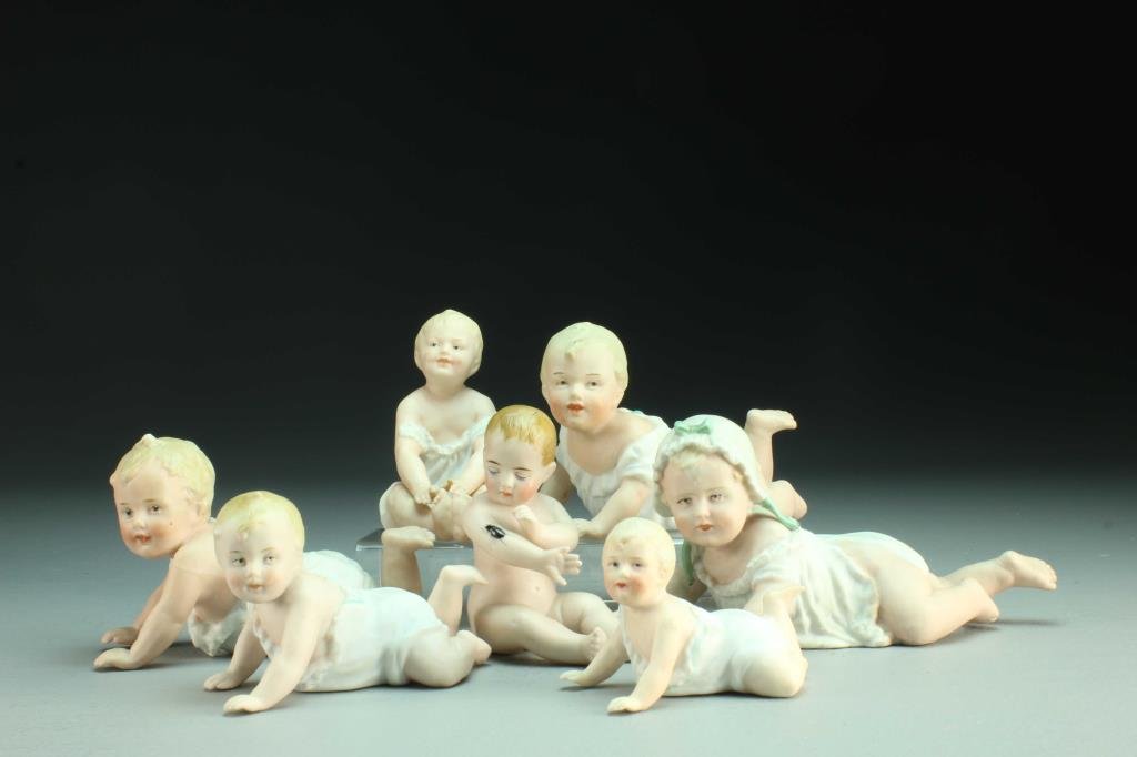 (7) Pcs Bisque Porcelain Piano Babies: To include seven piano babies in various playful crawling and seated positions, five with bases impressed with Heubach hallmark, two apparently unmarked, largest measures 6.5"L, circa 19th century. Co