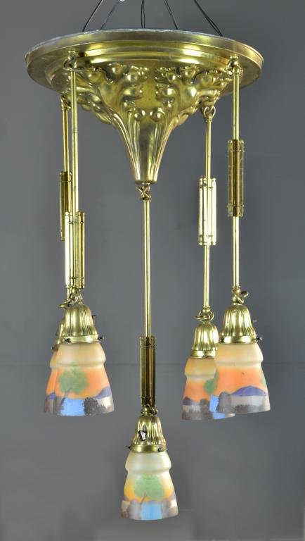 A Brass and Hand Painted Glass Five Light Chandelier: Having a ciruclar tapering brass ceiling mount with embossed scrolling leaf decoration, five suspending lights each having hand painted glass shade depicting landscapes, measures 16"D, circa 20th cent