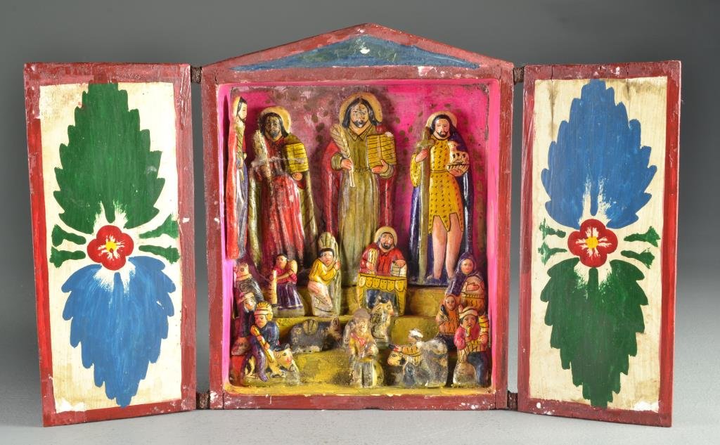 A Mexican Hand Carved Wood Altar Box: A hand made Santo family altar box with fabric hinged doors containing carvings of saints and religious figures overlooking other various figures and animals, measures 11"H x 8.75"W closed, 18.25"W op