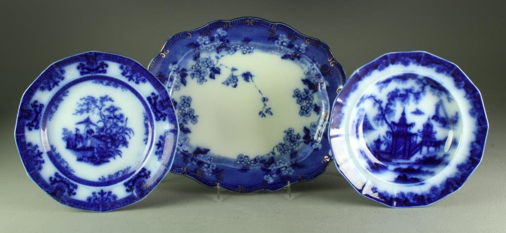 (3) Pieces Flow Blue Porcelain: To include a large platter decorated with flowers and highlighted in gilt, impressed 897, with additional painted numbers, 15" L, a scalloped plate impressed Davenport decorated in the Asian taste, 10