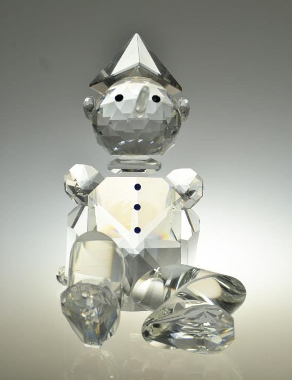 A Gina Truex Crystal Zoo Figurine: A sculpture formed as Pinnochio, signed Gina Truex and Copyrighted for Zoo Crystal, measures 4.75"H.