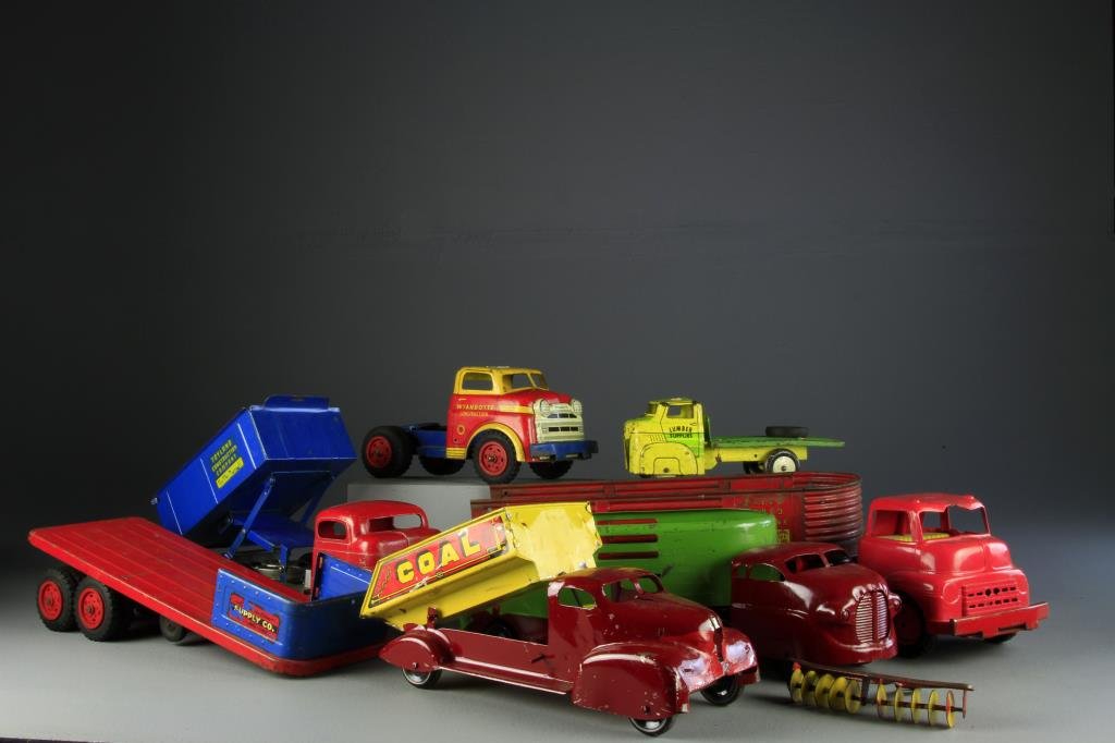 (7) Pressed Steel Trucks Including Wyandotte: To include four various Wyandotte trucks including lumber, two Structo including dump truck and one Marx coal truck, largest measures 22" L, circa mid 20th century. Condition, all with normal surface 