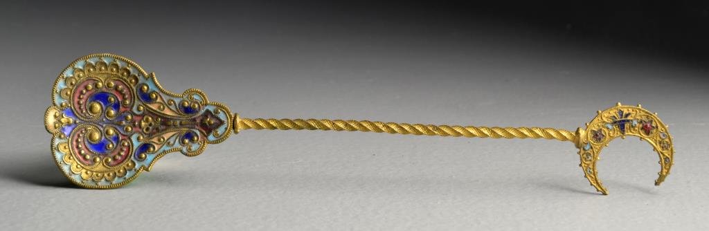 An Islamic Enamel Spoon: The spoon having a crescent moon atop the handle molded as a twisted rope, the spoon finely enameled with vibrant cobalt blues, turquoise, and red, a very nice example measuring 6.875"L, circa late 19