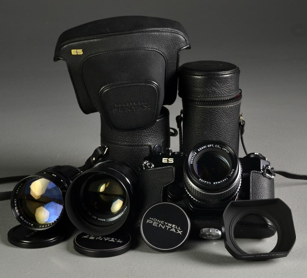 (5) Camera & Lenses Incl. Pentax: To include a Honeywell Pentax ES 35mm No. 6522186 in original case, two Super Multi-Coded Takumar lens, a Takumar lens cover and a Komura lens, all in fitted cases, unknown working order.