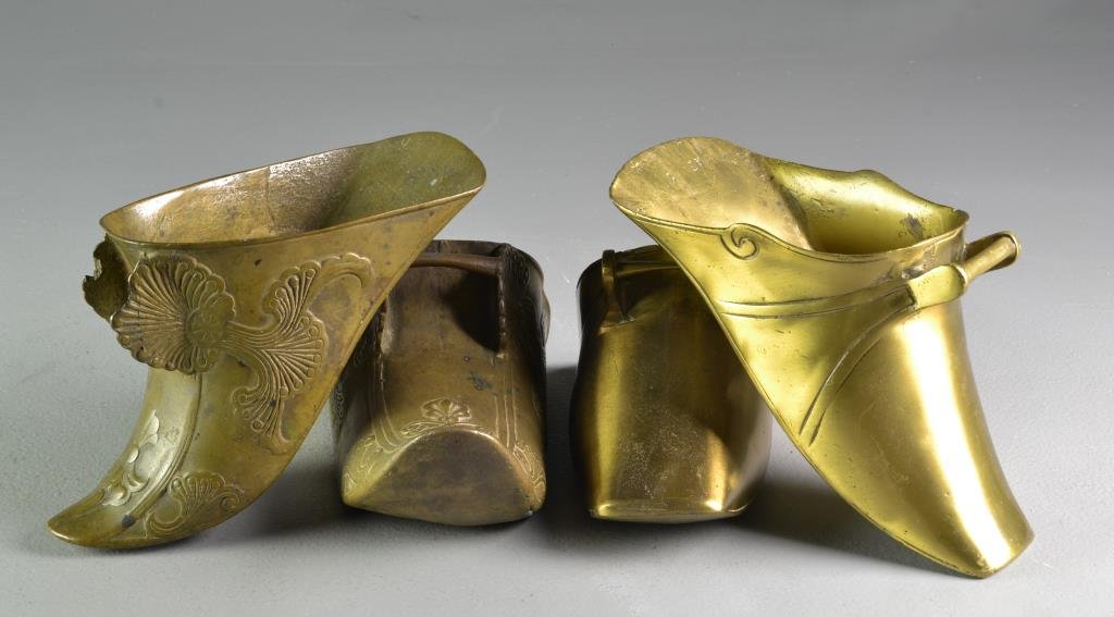 (2) Near Pairs Spanish Colonial Brass Stirrups: To include one pair of footed stirrups with incised line design, together with a near pair having floral and figural designs, largest measures 10"L, circa late 19th-early 20th century. Condition, one 