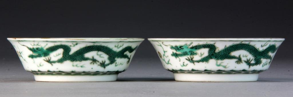 Pr. Chinese Green & White Porcelain Low Bowls: Finely painted to depict dragons chasings flaming pearls, base bearing seal mark in underglaze blue, 1.25"H X 4.5"D.