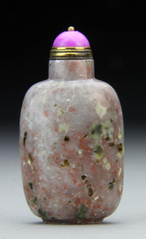 Chinese Qing Spotted Jasper Snuff Bottle: Natural spotted Jasper snuff bottle in flattened oval shape sitting on a raised oval foot. Very well hollowed with a pink Peking glass topper and brass spoon, neck is concave. 3"H, circa late 19th/ear