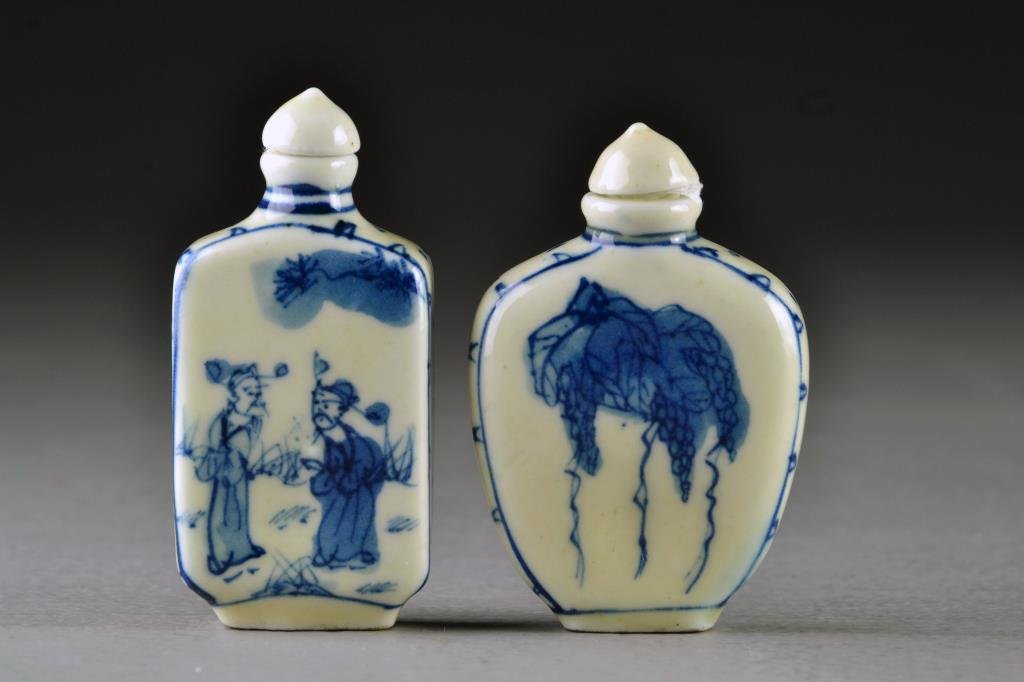 (2) Chinese Blue and White Porcelain Snuff Bottles: Finely painted at center to depict bunches of grapes, a cricket and figures in a landscape, each having border design and bases marked by a leaf in underglaze blue, tallest is 2.9"H.