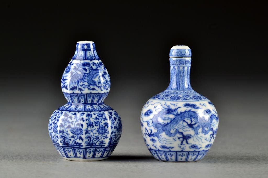 (2) Chinese Blue and White Porcelain Snuff Bottles: Each finely painted in great detail to depict phoenix among scrolling floral design and three clawed dragons among ruyi clouds, bases bearing three character mark in underglaze blue, tallest is 2.6"H.