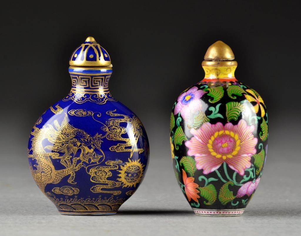 (2) Chinese Porcelain Snuff Bottles: One a famille noir example painted with floral design, the other a cobalt blue bottle with gold painted depiction of five clawed dragon among ruyi clouds, bases bearing four character mark in iron red