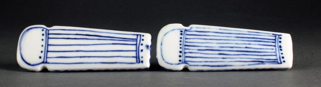 (2) Chinese Blue and White Porcelain Snuff Bottles: A pair of blue and white porcelain examples formed and painted as harps with floral decoration, underside four character marked in underglaze blue, one complete with flat matching stopper, both measur