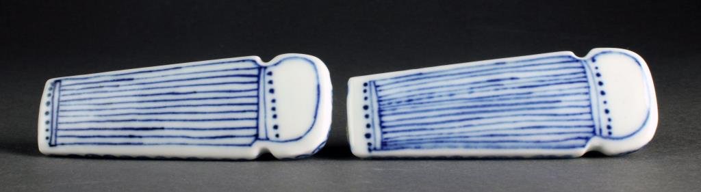 (2) Chinese Blue and White Porcelain Snuff Bottles: A pair of blue and white porcelain examples formed and painted as harps with floral decoration, underside four character marked in underglaze blue, complete with flat porcelain stoppers, both measure