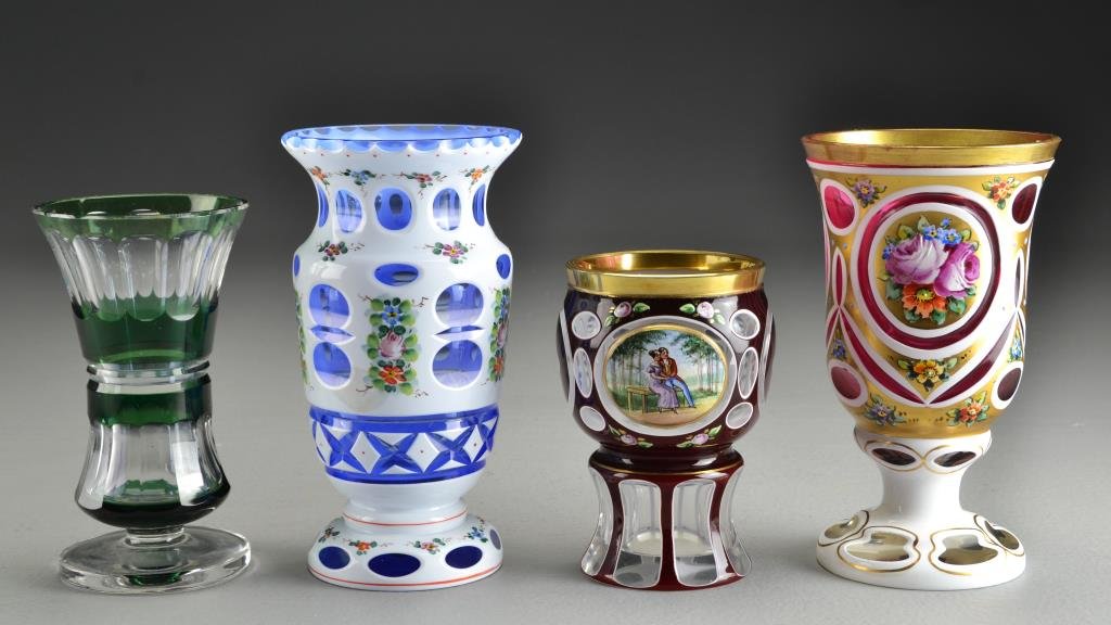 (4) Bohemian Cased & Cut Glass Pieces: To include two enameled examples, one cased to blue and one cased to cranberry, both depicting flowers, along with two glasses, one having a painted scene and the other cased green to clear, largest m