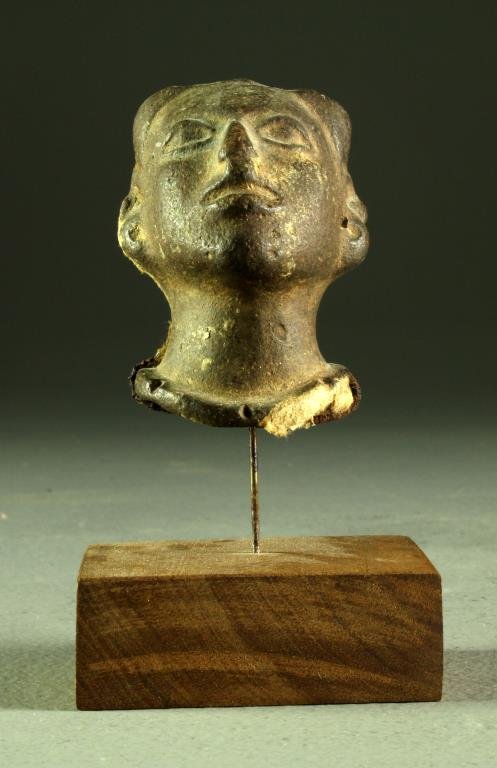A Fine Pre Columbian Pottery Bust: Having finely molded details and mounted to wood and metal display stand, lacking portion of the back of its head, head measures 3.25"H, circa 600 AD.