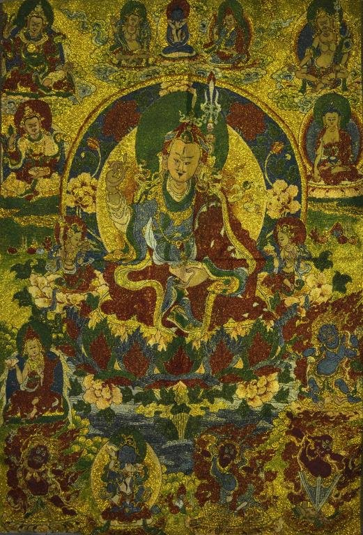Chinese or Tibetan Figural Textile: Depicting a seated Buddha on a lotus throne surrounded by other Buddhist gods, 35"H X 23.5"W.