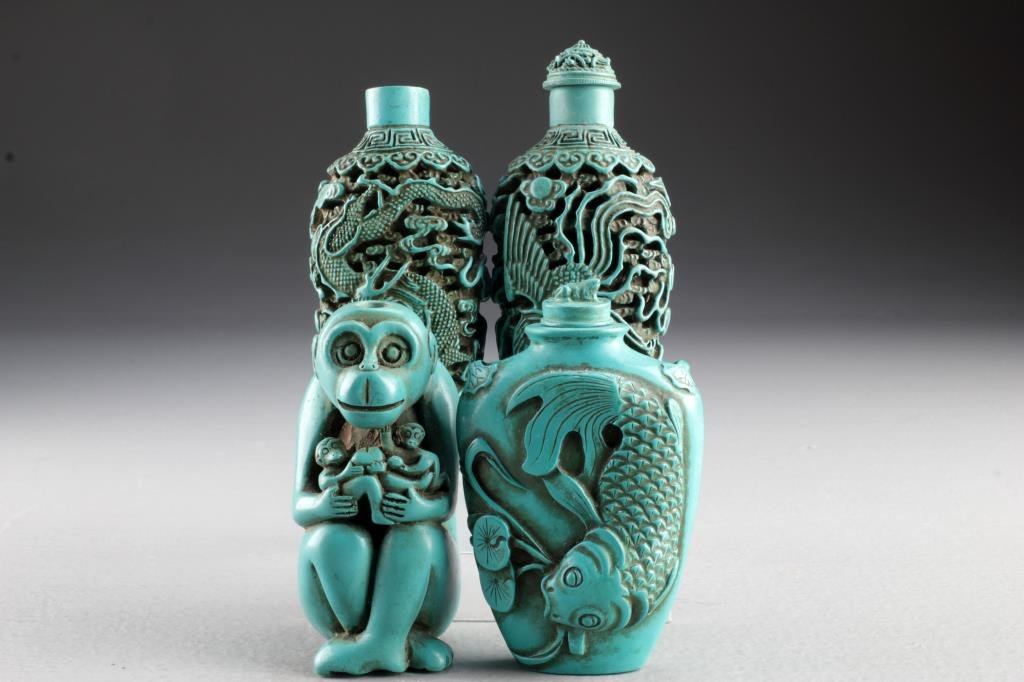 (4) Chinese Molded Snuff Bottles: To include four molded composition bottles, one formed as a seated monkey, one with koi fish and calligraphy, two with depiction of dragon and phoenix, two with stoppers and spoons, tallest is 3.5"H.
