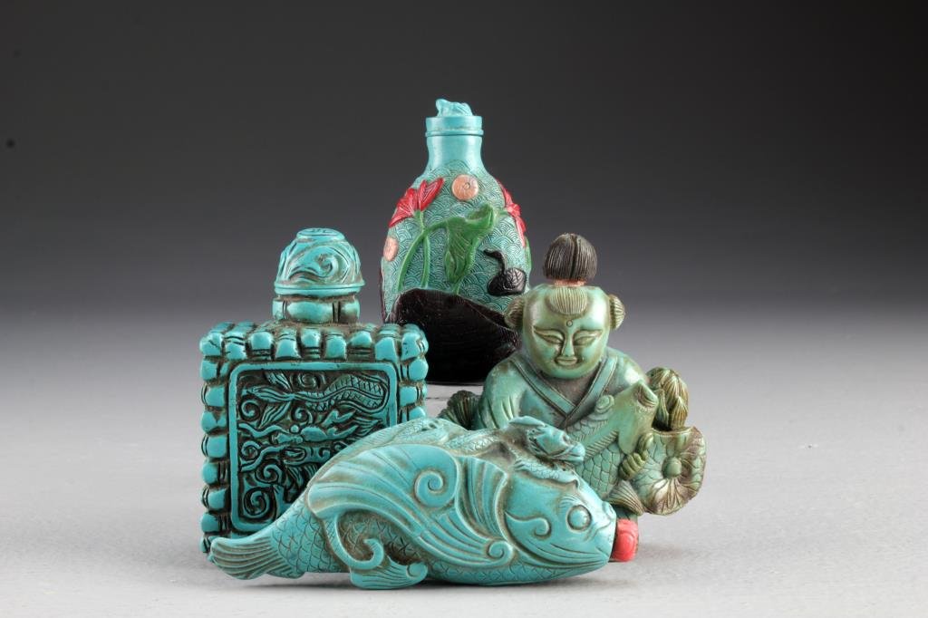 (4) Chinese Molded Snuff Bottles: To include four molded composition bottles, one formed as figure holding fish, one formed as a dragon atop fish, an example with overlay depicting lotus and duck, and one formed as a box with dragon d