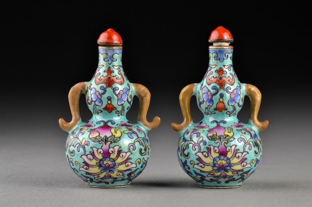 (2) Chinese Famille Rose Porcelain Snuff Bottles: Each having gourd form and scrolling handles, finely painted with scrolling floral design, pomegranates and bats, bases marked by iron red seal underglaze, both measure 3.2"H.