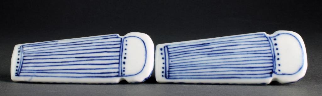 (2) Chinese Blue and White Porcelain Snuff Bottles: A pair of blue and white porcelain examples formed and painted as harps with floral decoration, underside four character marked in underglaze blue, complete with flat porcelain stoppers, both measure