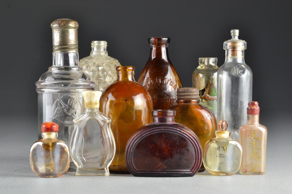A Grouping of (10+) Chinese Glass Bottles: An assortment of glass bottles of various form, size and color, largest measures 5.5"H.