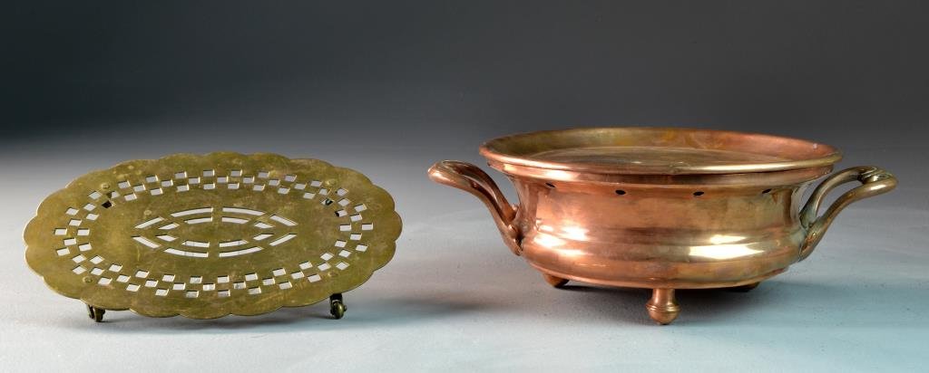 (2) Antique Copper and Brass Table Articles: To include a F H copper dish warmer with pireced edge, scrolled acanthus leaf handles raised on tapered circular feet, along with a French Marlux pierced brass trivet raised on casters, largest measur
