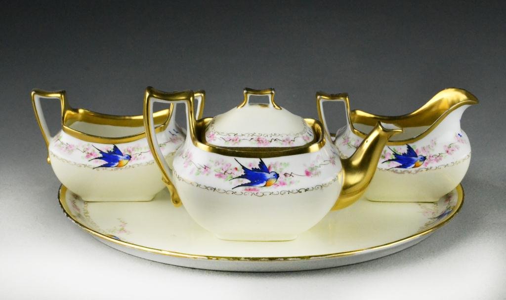 (4) Pc. Hand-painted Bavarian Porcelain Tea Service: Depicting bluebird of happiness with heavy gilt decoration, marked Z.S. & Co. to bottom, largest is 12" D. Condition: good. Property of Sena Bowling, Davison, Michigan.
