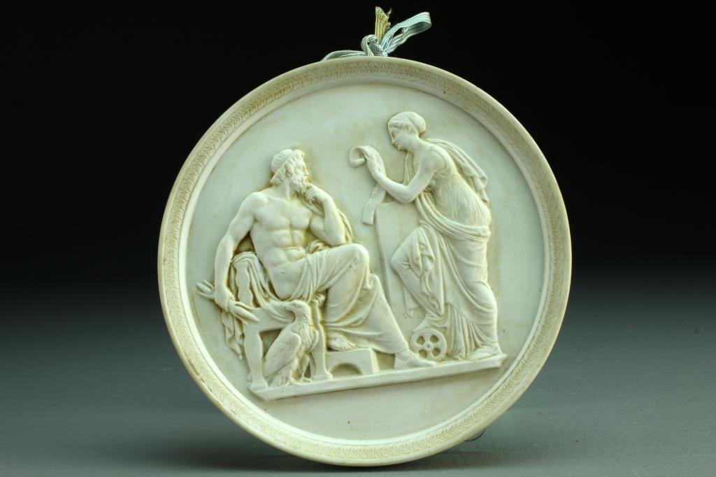 A Parian Porcelain Plaque: A round parian plaque depicting classical figures in bas relief at center, reverse impressed with Eneret L, with two small holes to top and back for hanging, measures 5.5"Dia., circa early 20th centur