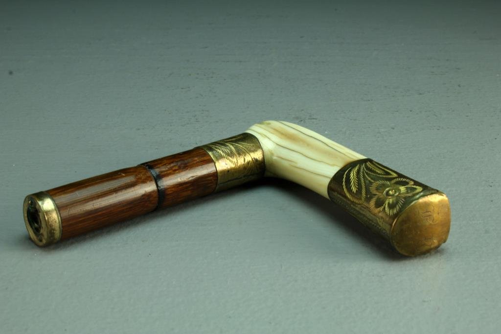 An Antique Carved Bone, Brass and Bamboo Cane Handle: A finely carved bone handle with brass mounts having etched flowers and patterned striping, front having "1914" etched within a heart, measures 5"H, circa early 20th century. Condition, overall surfac
