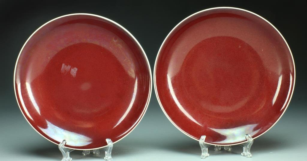 Pr. Chinese Sang de Boeuf Porcelain Plates: Having a deep ox blood glaze, raised on short foot ring with slightly flared rims, base with six character mark within two concentric circles in underglaze blue, 1.75"H X 9.5"D.