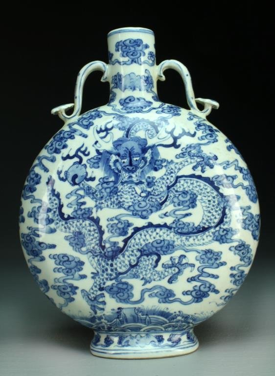 Chinese Blue & White Porcelain Moon Flask: Finely painted on each side to depict five clawed dragons amongst ruyi clouds holding a flaming pearl, with two ruyi handles, raised on short foot ring, base having seal mark in underglaze blue, 10.75