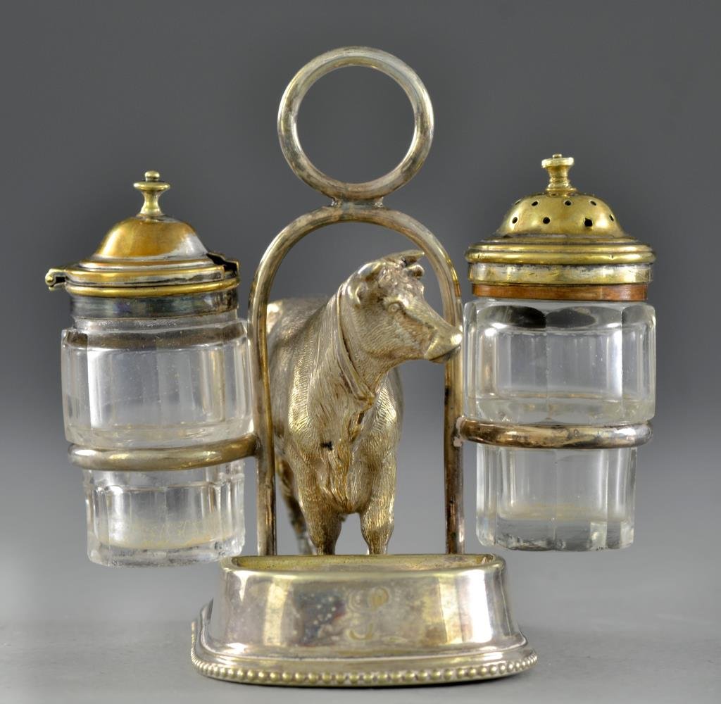 Thomas Wilkinson Silver Plate Cow Caddy: A silver plated caddy with glass salt and pepper containers flanking loop handle, at the center a cow with small indented tray at feet, top of base with diamond and letter mark, possibly an export sta