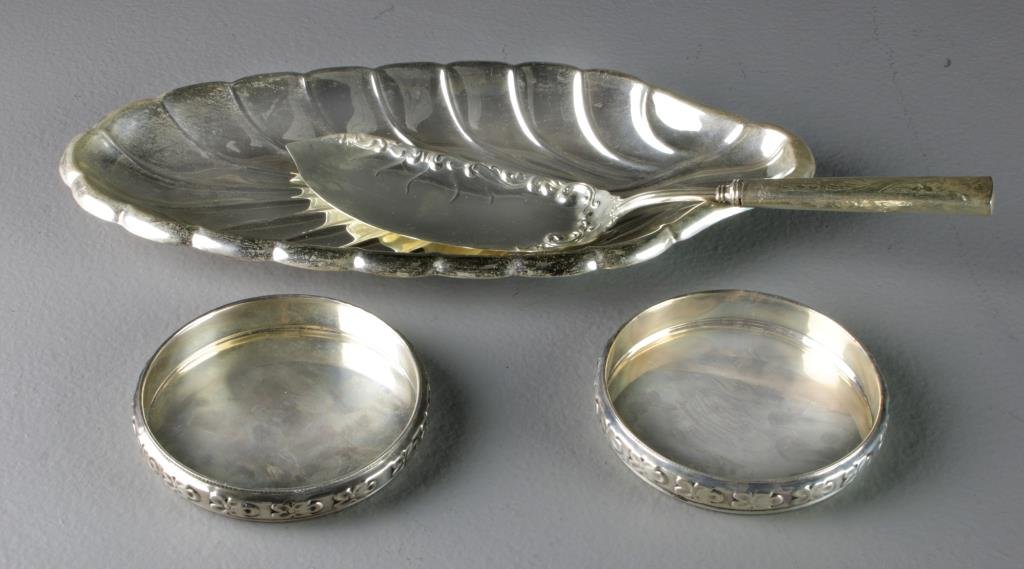 (4) Pcs Sterling Silver Table Ware: To include a Reed & Barton celery tray, two Edward San Giovanni wine bottle coasters and a sterling handled fish server, largest measures 12.5"L, total weight 18 ozt, circa mid 20th century.